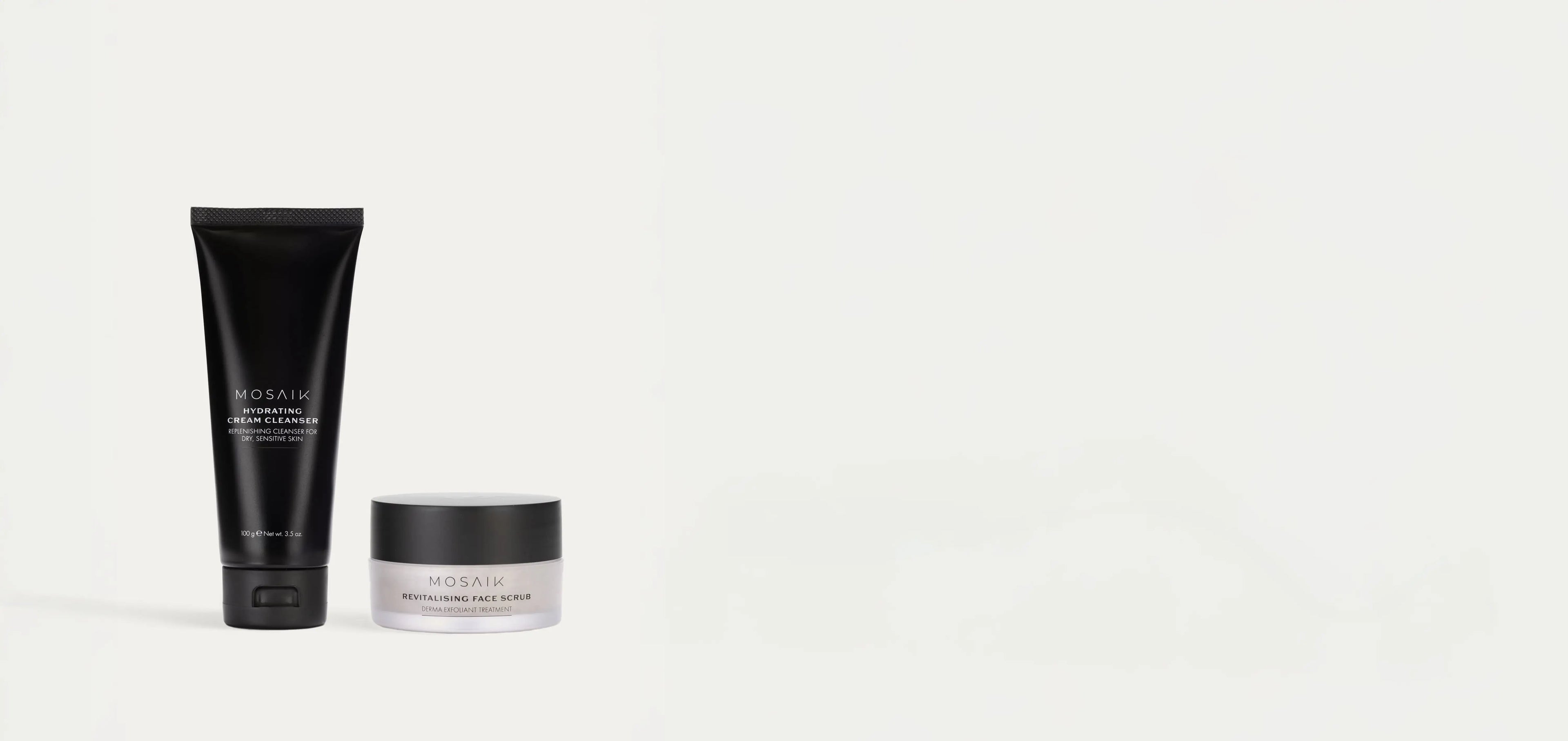 Mosaik Hydrating Cream Cleanser and Revitalising Face Scrub skincare products in sleek black and frosted packaging, displayed on a white background.