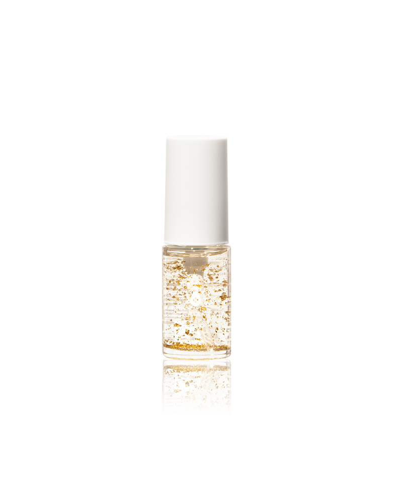 A small transparent bottle of Makanai Skin Jewel Serum with visible gold flakes and a white cap. The product is shown against a transparent background.