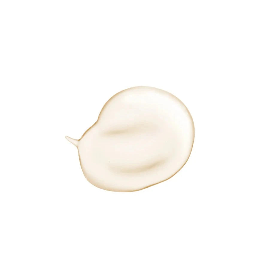 A close-up of a smooth, light beige cream texture on a white background. The soft sheen and creamy consistency suggest a rich, moisturizing skincare product.