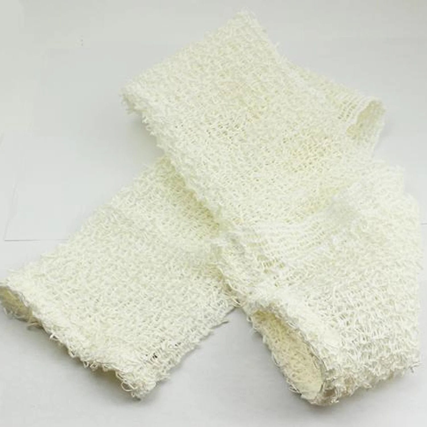 A folded piece of white woven mesh fabric with a soft, textured surface. The material appears lightweight and flexible, displayed against a plain white background.